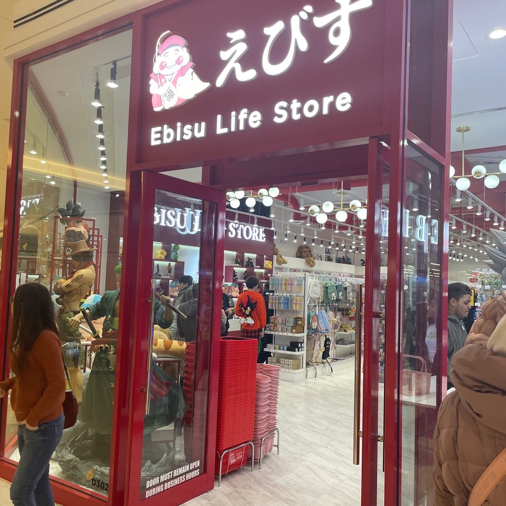 a woman standing in front of the store a woman standing in front of the store