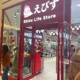 a woman standing in front of the store a woman standing in front of the store