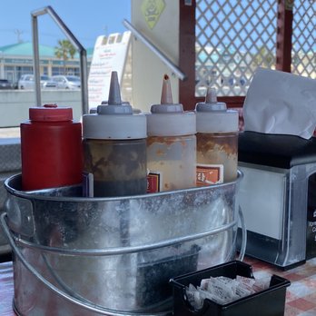 Smoked Bbq - a bucket of condiments on a table - Barbeque Near Me - Key West, Florida