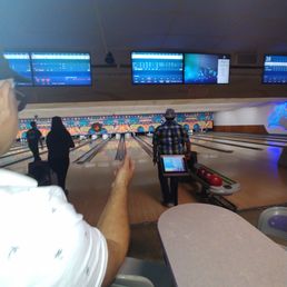 a man playing bowling a man playing bowling