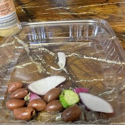 Olives, mini cucumber with a spot on it and chunks of onions