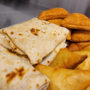 Safari Secrets - a plate of food including a burrito and french fries - African Near Me - Oshawa, Ontario Safari Secrets - a plate of food including a burrito and french fries - African Near Me - Oshawa, Ontario