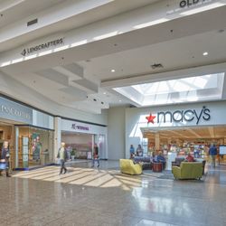 Eastland Mall - Sunlit seating area outside Macy's and LensCrafters at Eastland Mall.