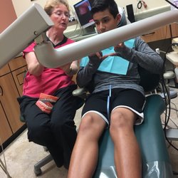 Alicia L Dwyer, DDS PA - Dr. Dwyer educating Bradley on how to properly use floss.
