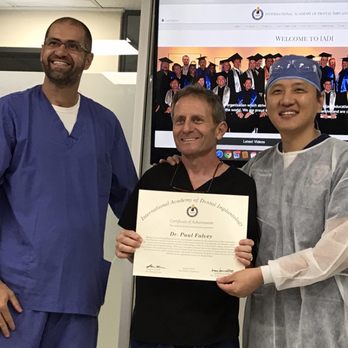 Paul Falvey - Dr. Falvey receiving an award from Drs. Albek (left) and Dr. Lee (right) founder of the International Academy of Dental Implants. - General Dentistry Near Me - Grass Valley, California