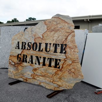 Surfaces PCB - a large granite block with the words absolute granite on it - Flooring Near Me - Panama City Beach, Florida