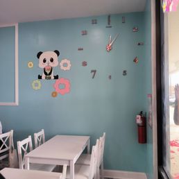 a table and chairs with a clock on the wall a table and chairs with a clock on the wall