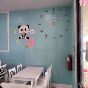 Mochinut - a table and chairs with a clock on the wall - Hot Dogs Near Me - Jacksonville, Florida Mochinut - a table and chairs with a clock on the wall - Hot Dogs Near Me - Jacksonville, Florida