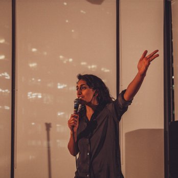 Do What You Love Comedy Series - a woman speaking into a microphone - Comedy Clubs Near Me - San Francisco, California Do What You Love Comedy Series - a woman speaking into a microphone - Comedy Clubs Near Me - San Francisco, California
