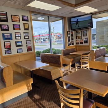 Bojangles - Some booths and tables with chairs occupy the dining area. You can also see one of the walls filled with placks who sport team photos. - Southern Near Me - Vinton, Virginia