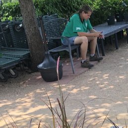 Unhelpful, rude employee on smoke break. A smoking area in a garden center....GROSS!