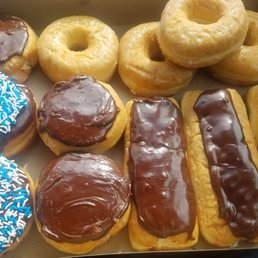 a variety of doughnuts in a box a variety of doughnuts in a box