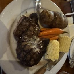 Prime cut Ribeye steak, baked potato and root vegetables