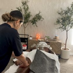 Letting fire cups sit while massaging the legs for a full body experience