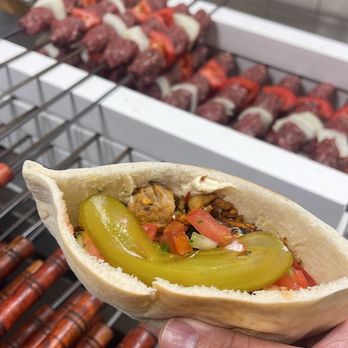 Mashawee Guy - a hand holding a hot dog - Middle Eastern Near Me - Oak Lawn, Illinois