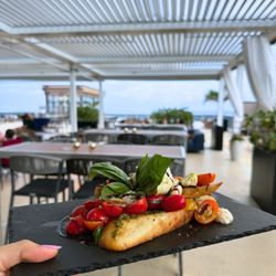Pier 6 Rooftop - Caprese, but make it bold.
Truffle burrata, heirloom tomatoes, pesto crostini, and a balsamic glaze you'll be dreaming about.