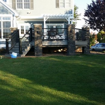 Walsh Custom Concepts - the back of a home with a deck and patio - General Contractors Near Me - Rochester, New York