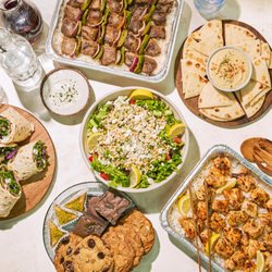 Grilled Chicken kabobs, Mediterranean Salad, hummus & pita, beef kabobs, desserts, rice, wraps and sauce.