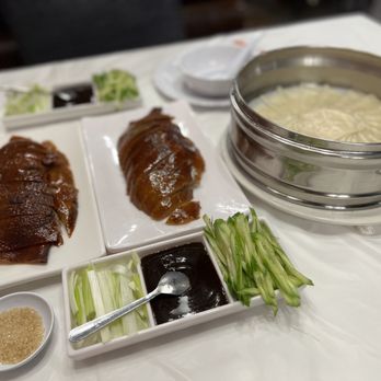Peking Impression - various dishes of food on a table - Chinese Near Me - Houston, Texas
