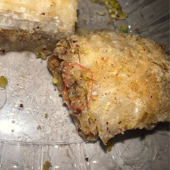 Naara Cafe - A thin wire-like piece of metal embedded inside the dessert. - Middle Eastern Near Me - San Antonio, Texas