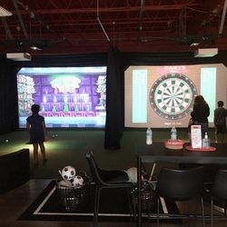 SIM Time Entertainment - The only TWO HD multi-sport simulators in New England! Shown left: Carnival toss; shown right: darts!