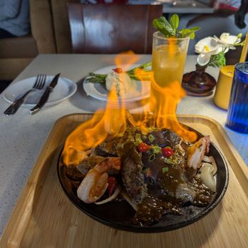 Poor Calvin's - Lamb loin with shrimp, presentation, on fire - Asian Fusion Near Me - Atlanta, Georgia Poor Calvin's - Lamb loin with shrimp, presentation, on fire - Asian Fusion Near Me - Atlanta, Georgia