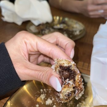 JZ Steakhouse - a hand holding a chocolate covered donut - Steakhouses Near Me - Hollywood, Florida JZ Steakhouse - a hand holding a chocolate covered donut - Steakhouses Near Me - Hollywood, Florida