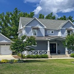 Re-Side Exterior Renovations - Beautiful large home, contrasting board and batten Hardie board, with traditional horizontal  siding treatment, trim, soffit, columns, porch