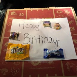 a happy birthday sign on a pizza box