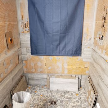 Romanoff Renovations - a toilet in the middle of a room - Flooring Near Me - Atlanta, Georgia