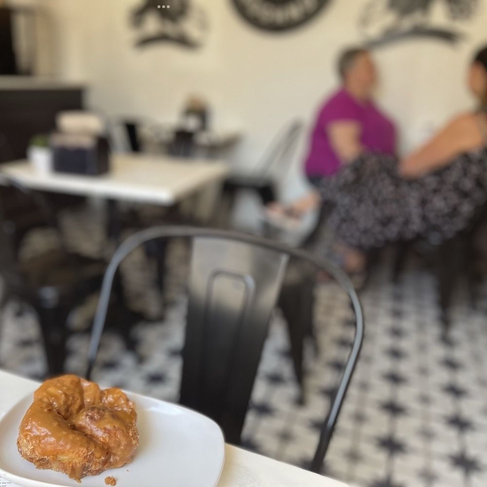 Parlor Doughnuts - My flakey rich bourbon caramel doughnut, from the window table towards - Donuts Near Me - Virginia Beach, Virginia Parlor Doughnuts - My flakey rich bourbon caramel doughnut, from the window table towards - Donuts Near Me - Virginia Beach, Virginia