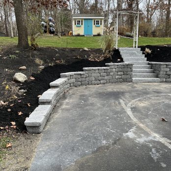 Lawrence Landscaping and Son - a driveway with steps leading up to a house - Landscaping Near Me - Plymouth, Massachusetts Lawrence Landscaping and Son - a driveway with steps leading up to a house - Landscaping Near Me - Plymouth, Massachusetts