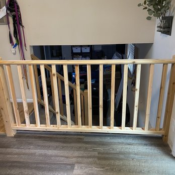 Longhouse Construction - a wooden baby gate in a living room - General Contractors Near Me Longhouse Construction - a wooden baby gate in a living room - General Contractors Near Me