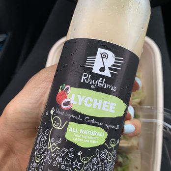 Chef Kofi - a hand holding a bottle of lychchee - Personal Chefs Near Me