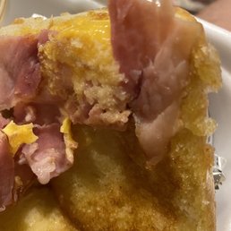a piece of bread with ham and cheese