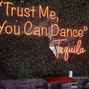 La Cantinita - a neon sign that says trust me you can dance tequila - Mexican Near Me - Levittown, New York