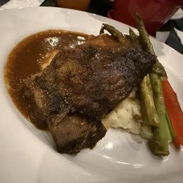 Braised beef over mashed potatoes and grilled bundled asparagus Braised beef over mashed potatoes and grilled bundled asparagus