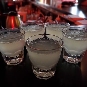 Streamline Tavern - a row of glasses filled with liquid - Dive Bars Near Me - Seattle, Washington
