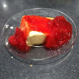 a piece of cheesecake with strawberry sauce a piece of cheesecake with strawberry sauce