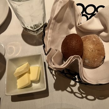 Salum Restaurant - a table setting with bread, butter and water - New American Near Me - Dallas, Texas Salum Restaurant - a table setting with bread, butter and water - New American Near Me - Dallas, Texas