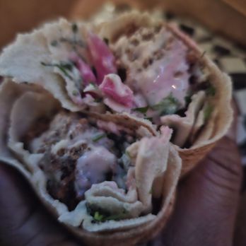 Carnival Restaurant - a hand holding a burrito - Middle Eastern Near Me - Sherman Oaks, California Carnival Restaurant - a hand holding a burrito - Middle Eastern Near Me - Sherman Oaks, California