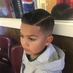 Ray's Barber Shop - Jose getting down with a medium fade with side part and line up.
