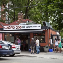 people standing outside of a restaurant people standing outside of a restaurant
