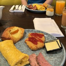 Eight at Cordis - Made-to-order omelet, hash browns, charcuterie, pastry, yogurt with mango compote