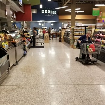 Publix - a woman pushing a shopping cart in a grocery store - Grocery Near Me - Apollo Beach, Florida