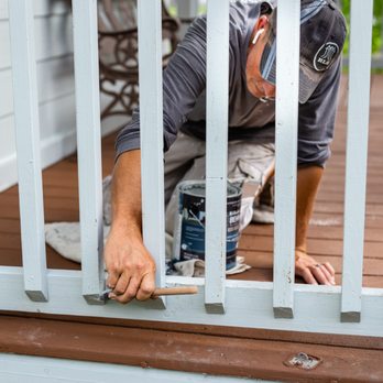 RLS Construction Remodel Design - a man working on a deck - General Contractors Near Me