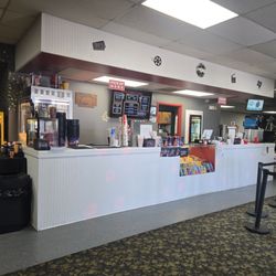 Concession stand with nachos, candy, drinks and popcorn. Salt choices for popcorn located to the left of the stand.