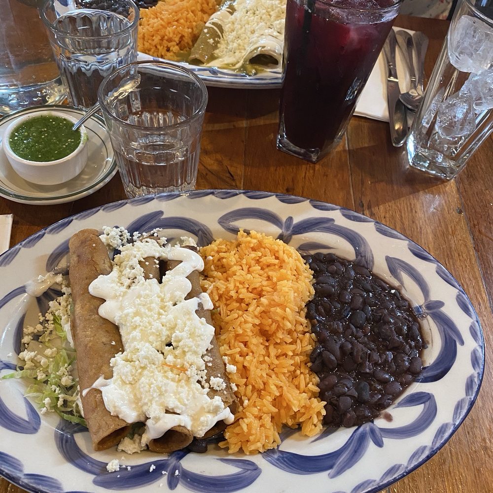 Chicken Flautas on bottom and my friend's enchiladas with hibiscus drink on top. Delicious and great presentation! Chicken Flautas on bottom and my friend's enchiladas with hibiscus drink on top. Delicious and great presentation!