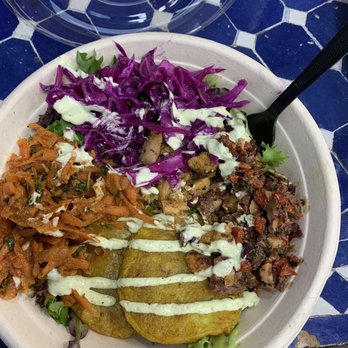 Zoa Moroccan Kitchen - Chicken, potato pancake, carrots, cabbage, and pickles and olives on a bed of greens drizzled with the mint avocado yogurt. - Moroccan Near Me - Houston, Texas