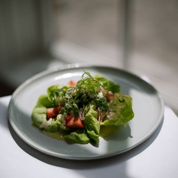 Hudson Garden Grill - a salad on a white plate - New American Near Me - Bronx, New York